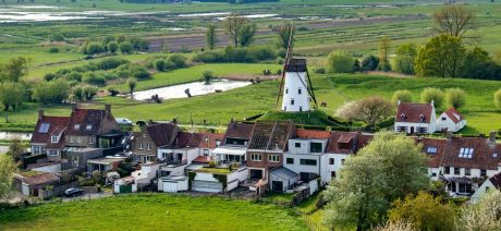 Aerial view of old windmill and village in the Netherlands