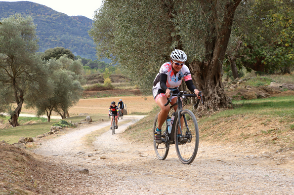 Woman riding gravel on the Girona Gravel bike tour