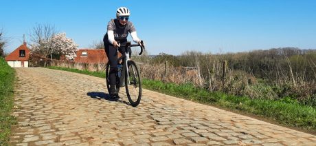 Woman riding on cobbles.