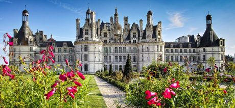 A frontal view of Chateau Chambord and the gardens in the foreground