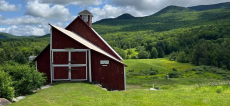 Large barn amidst rolling, forested hills