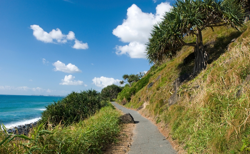 View of paved path on a hillside by the ocean