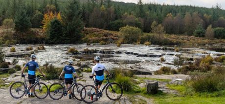 A group of three gravel bikers riding in Scotland.