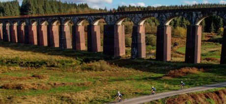 An arieal view of people riding gravel bikes under a bridge in Scotland
